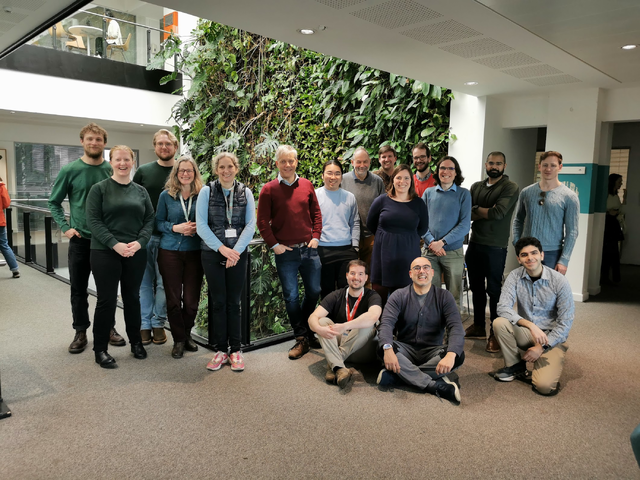 The project team in front of a living plant wall