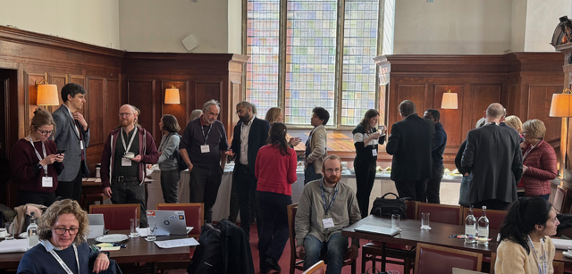 Participants talking between sessions at the evidence synthesis workshop